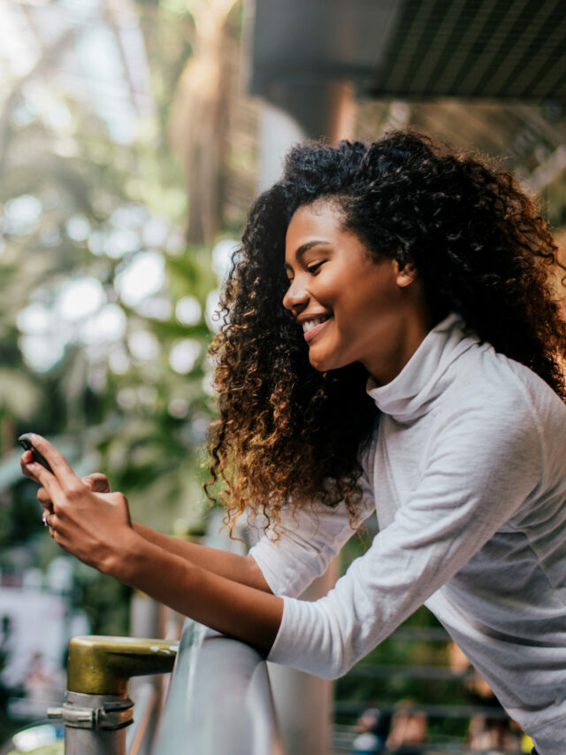 Side view of beautiful woman using her phone indoors.