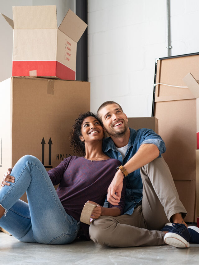 Multiethnic couple in new home with boxes