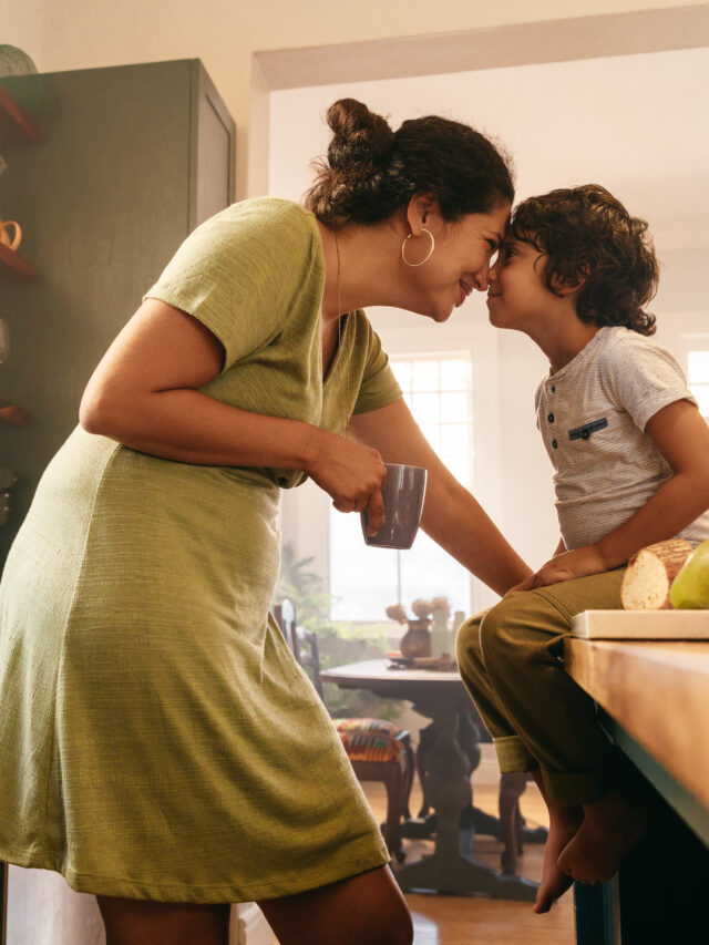 Stories Affectionate mother touching noses with her young son